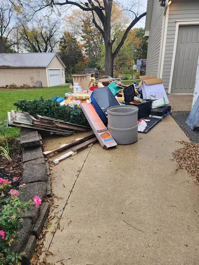 Dumpster being loaded with debris for Roofing Dumpster Rental in Shorewood